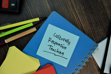 culturally responsive teaching write on sticky notes isolated on wooden table.