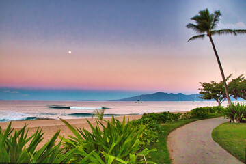 Full moon setting over the ocean with Molokai in the distance, seen from the path at Kaanapali Beach on Maui at twilight.