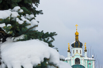 Winter landscape - Orthodox church in the snow among fir-trees on a cold frosty day