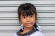 © Pannarai - Cute Asian little girl wearing a school uniform looking at the camera and smile.