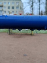 Frozen Small Water Droplets On Blue Metal Pipe And Blurred Background