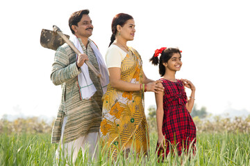 Wall Mural - Happy Indian family in agricultural field