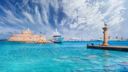 Landscape with Mandraki Harbour and two statues, Elefos and Elafina in Rhodes Island, Greece