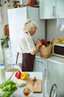 © Viacheslav Yakobchuk - Lovely old woman checking groceries basket in kitchen