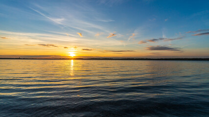 Wall Mural - A beautiful sunset behind a lake