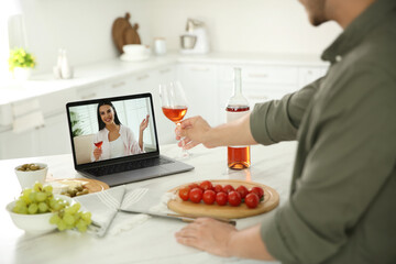 Poster - Friends drinking wine while communicating through online video conference in kitchen. Social distancing during coronavirus pandemic