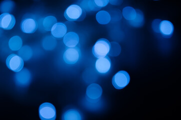 Abstract pattern of blue bokeh lights on black background