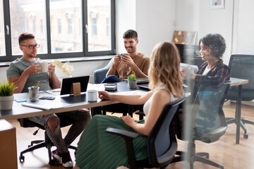 business, people and corporate concept - team of startuppers drinking coffee at office