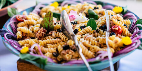 Close up of tasty and colorful recipe full of italian fusilli pasta with vegetables and tuna - healthy mediterranean diet lifestyle food concept