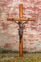 Jesus on the cross in front of an ancient wall