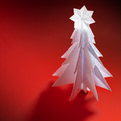 Wall Mural - Christmas trees made of paper on red background. Christmas card