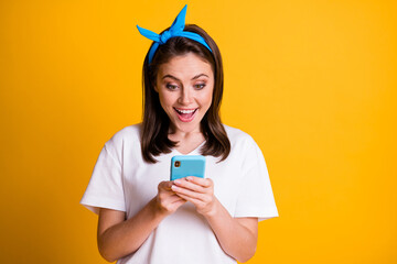 Canvas Print - Photo portrait of surprised female blogger reading comment subscribing using app isolated on vivid yellow color background