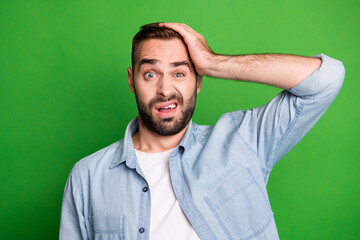 Canvas Print - Portrait of upset guy hand head wear blue shirt isolated on vibrant green color background