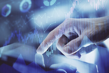 Multi exposure of man's hands holding and using a digital phone and forex graph drawing. Financial market concept.