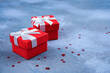 Two red gifts, star confetti on blue concrete background. Merry Christmas, New Year, present, card concept. Close-up, copy space