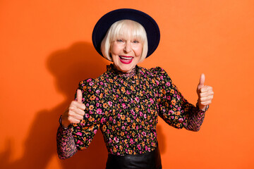 Sticker - Photo portrait of funny cheerful grandmother in stylish outfit showing like thumb-up gesture smiling isolated on bright orange background