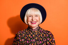 Headshot Of Positive Laughing Stylish Granny Wearing Printed Blouse Hat Smiling With Red Lipstick Isolated On Bright Orange Color Background