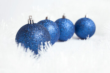 christmas balls in a row on snow and white background