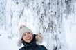 © Jamo Images - Cheerful young Asian woman looking up under a tree in winter