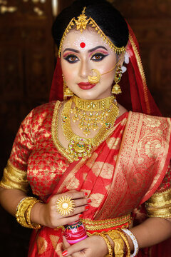 Portrait of very beautiful Indian bride holding traditional wooden sindur or sindoor box in hand