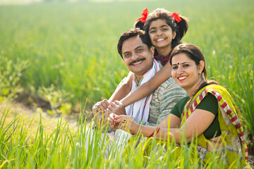 Wall Mural - Happy Indian family in agricultural field