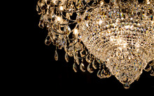 Luxury Chandelier Lamp With Crystal Sparkle Golden Light Furniture Decorated In Modern Condominium Or Elegant Hotel For Gala Dinner Isolated On Black Background With Copy Space