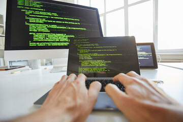 Wall Mural - close-up of computer programmer typing codes for new software on laptop