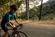 © David Fuentes/ADDICTIVE STOCK - mature woman training road bike, climbing a mountain road, side view