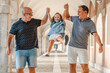 © Si And Si/ADDICTIVE STOCK - Cheerful fathers lifting cute girl above ground while walking along passage in city at weekend in summer