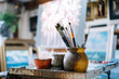 © Victor Gonzalez/ADDICTIVE STOCK - Close up view of pot with various brushes in art workshop
