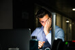 © David Prado/Stocksy - Tired businessman working late in office