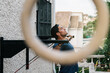 © David Prado/Stocksy - Active man training with sport equipment near house