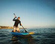 © Erik Isakson/Blend Images - Caucasian man on paddle board in ocean