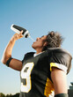© Erik Isakson/Blend Images - Hispanic football player drinking water