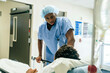© FS Productions/Blend Images - Black nurse talking to boy in hospital bed