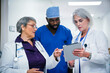 © FS Productions/Blend Images - Doctors and nurse discussing digital tablet