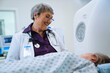 © FS Productions/Blend Images - Doctor talking to patient at scanner