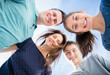 © JGI/Jamie Grill/Blend Images - Portrait of smiling Caucasian family in huddle