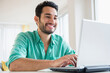 © JGI/Jamie Grill/Blend Images - Mixed race man using laptop