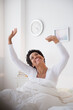 © JGI/Jamie Grill/Blend Images - Happy Black woman awaking in bed
