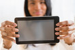 © JGI/Jamie Grill/Blend Images - Mixed race woman holding digital tablet