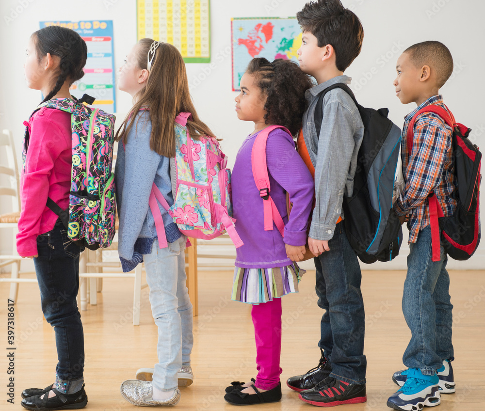 Students standing in line in classroom Stock Photo | Adobe Stock