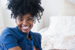 © JGI/Jamie Grill/Blend Images - Black woman smiling on bed
