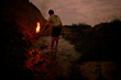© Aliyev Alexei Sergeevich/Blend Images - Mari man holding torch in rural creek