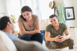 © JGI/Tom Grill/Blend Images - Hispanic friends talking in living room