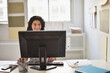 © JGI/Tom Grill/Blend Images - Mixed race businesswoman working on computer at desk in office