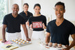 © JGI/Jamie Grill/Blend Images - Caterers smiling together with food and open sign in event space