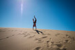 © Alberto Guglielmi/Blend Images - Caucasian teenage boy doing cartwheels on sand dune