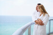 © JGI/Tom Grill/Blend Images - Couple hugging on balcony over ocean