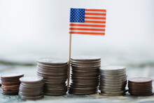 Close Up Of Stacks Of Coins With American Flag